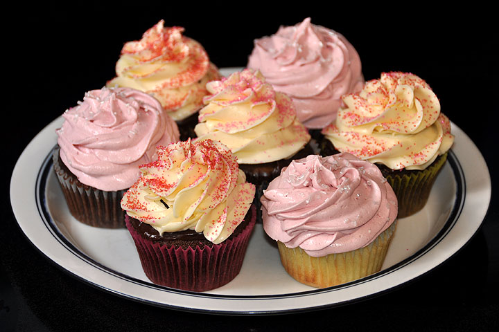 Devils-food with cherry filling and chocolate ganache;<br>also some with raspberry filling and raspberry icing;<br>also yellow cupcakes with raspberry filling and raspberry icing.